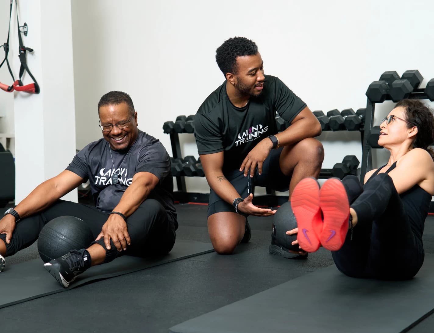 An AION coach guiding members through a strength session